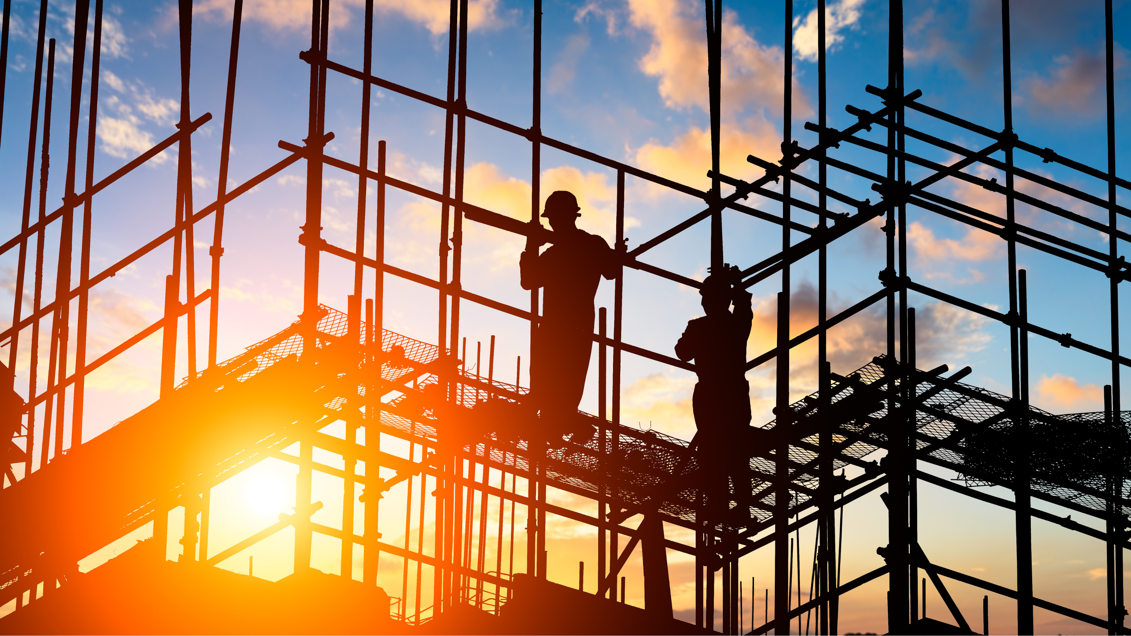 Construction workers at sunset