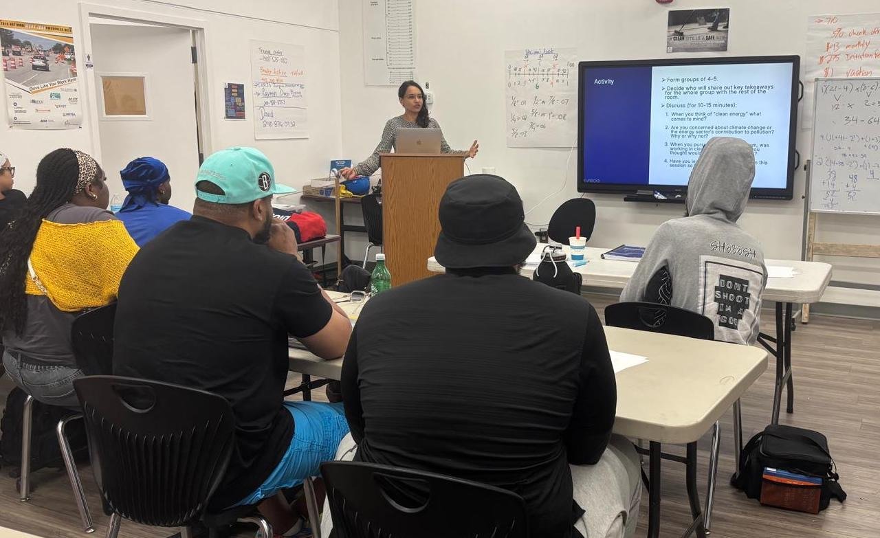 Maya Goodwin delivering a presentation to a class of students
