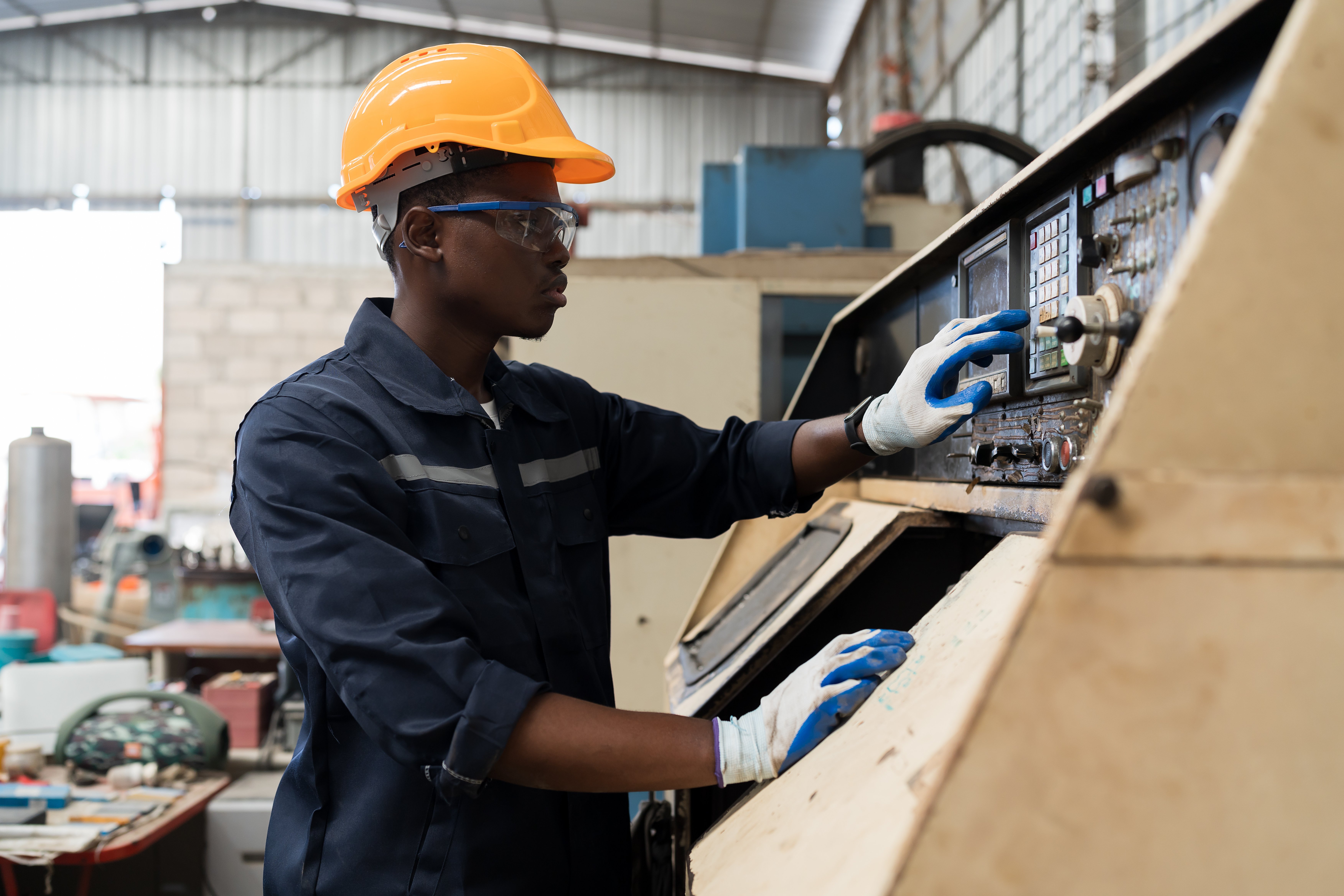 Male manufacturing worker with CNC machine